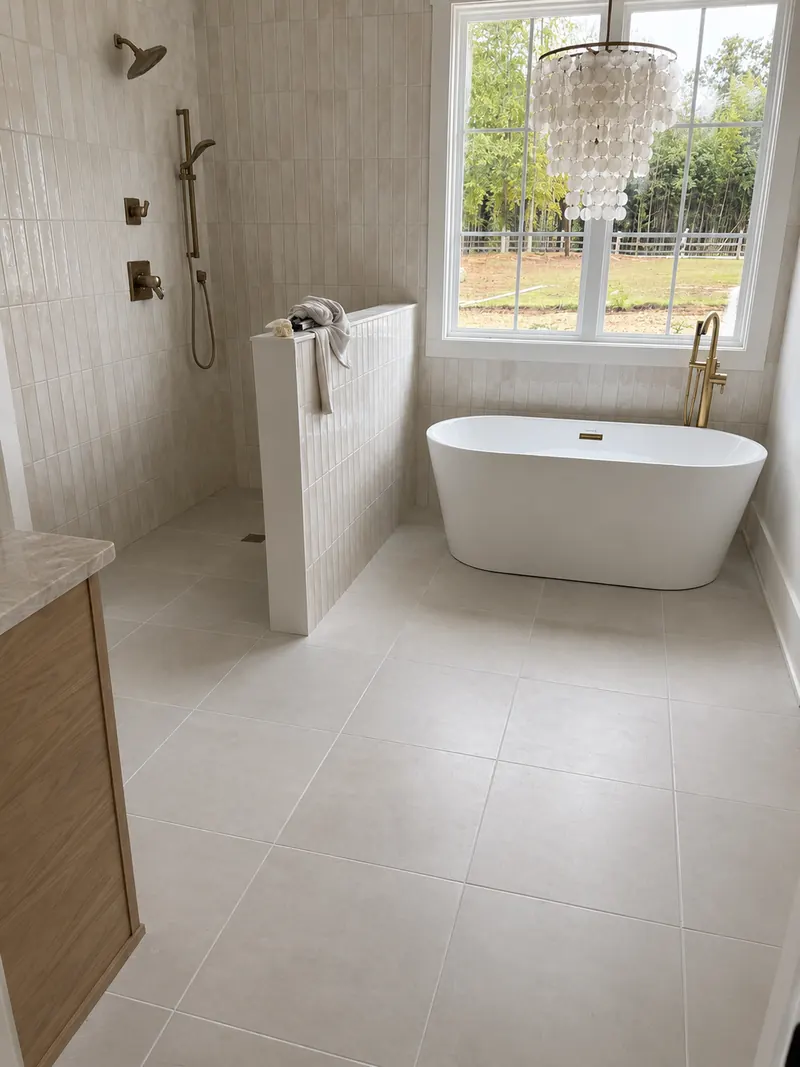 Primary bath with curbless shower, freestanding tub and capiz chandelier
